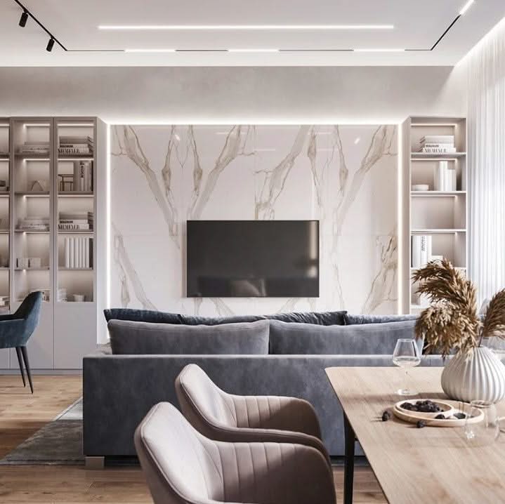 Modern living room with marble wall, gray sofa, and wooden coffee table.