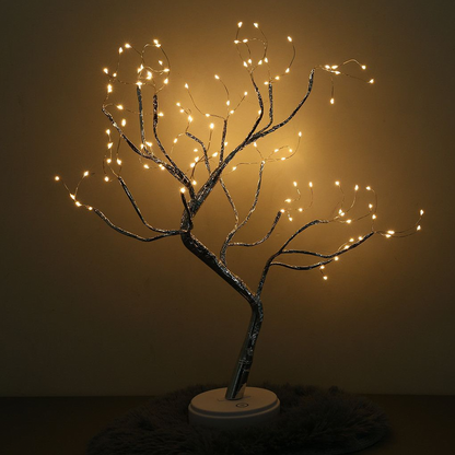 Decorative tree with string lights against a dark background