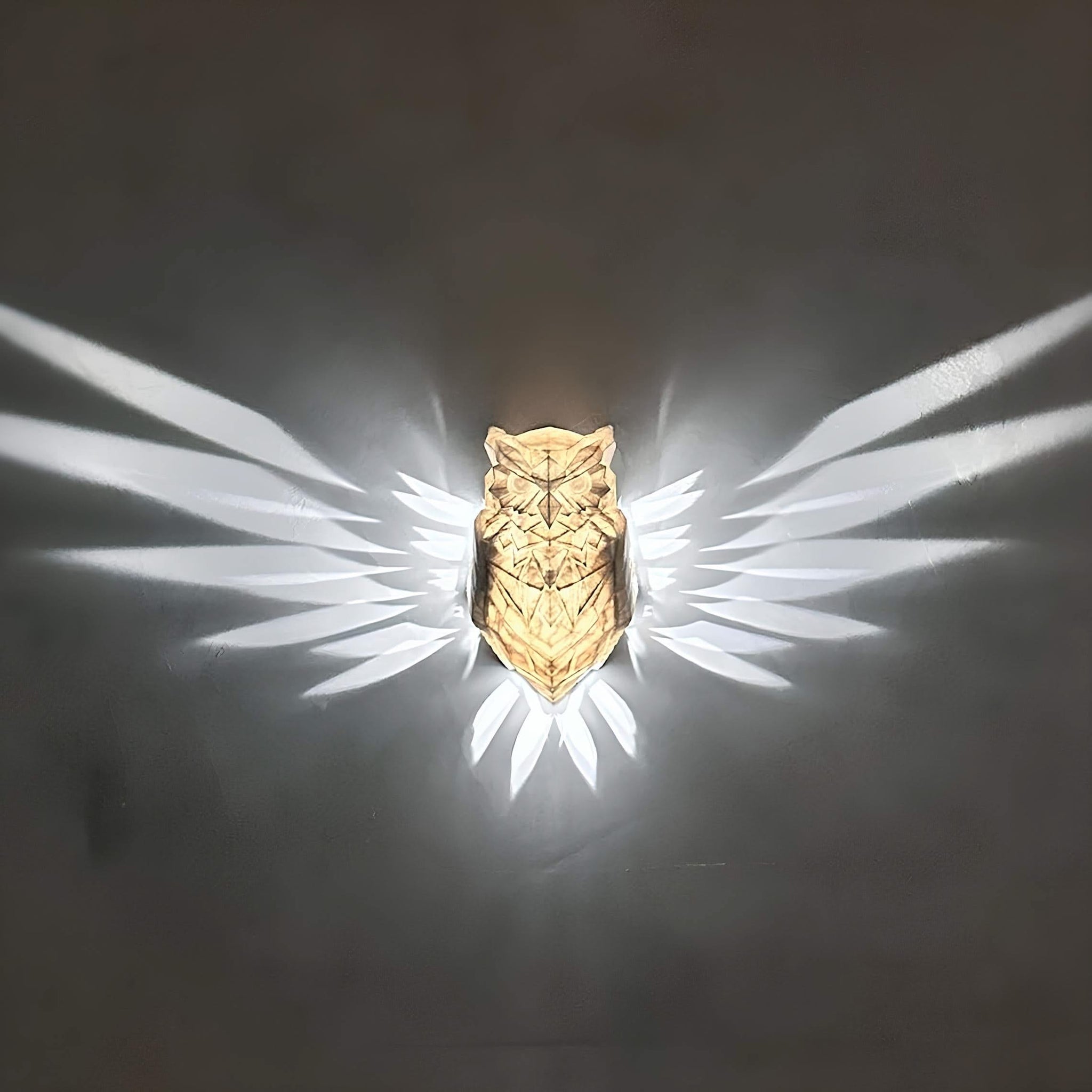 Gold owl-shaped object with a dark background