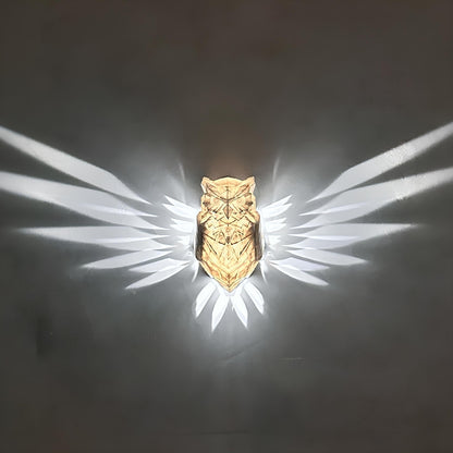 Gold owl-shaped object with a dark background