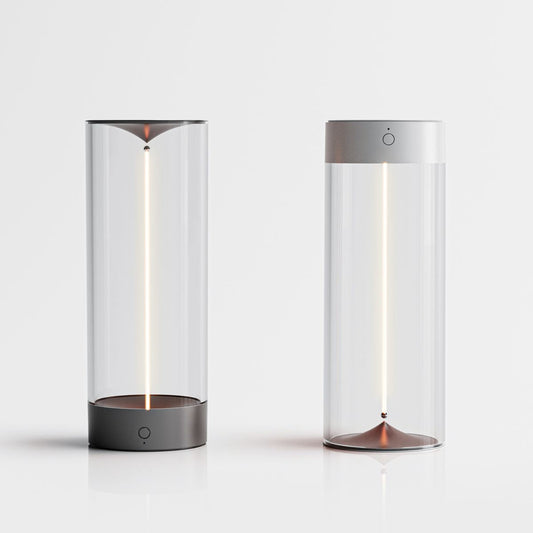 Two cylindrical lamps with glass covers on a white background