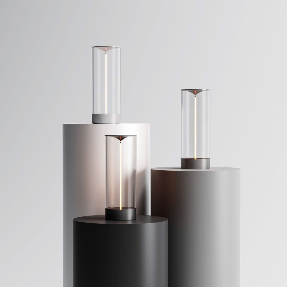 Modern outdoor lights on cylindrical stands against a light gray background