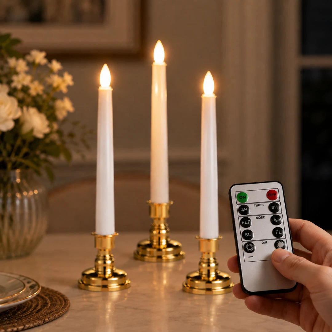 Josh & Tate - LumiCandle Standing LED Light - Three white taper candles in gold candlesticks are lit on a table, with a hand holding a remote control in the foreground.
