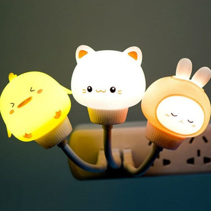 Three cartoon-style night lights shaped like animals on a dark background