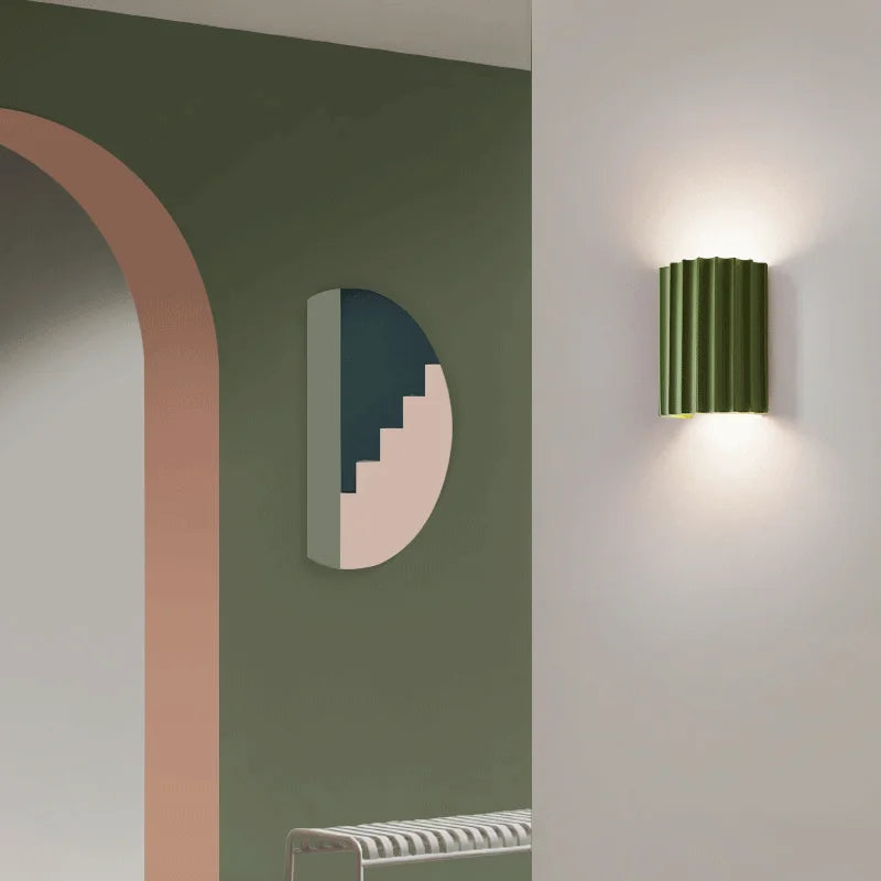 Modern wall lamp on a white wall with abstract wall art in the background