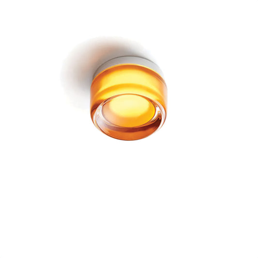 Round orange light fixture on a white background