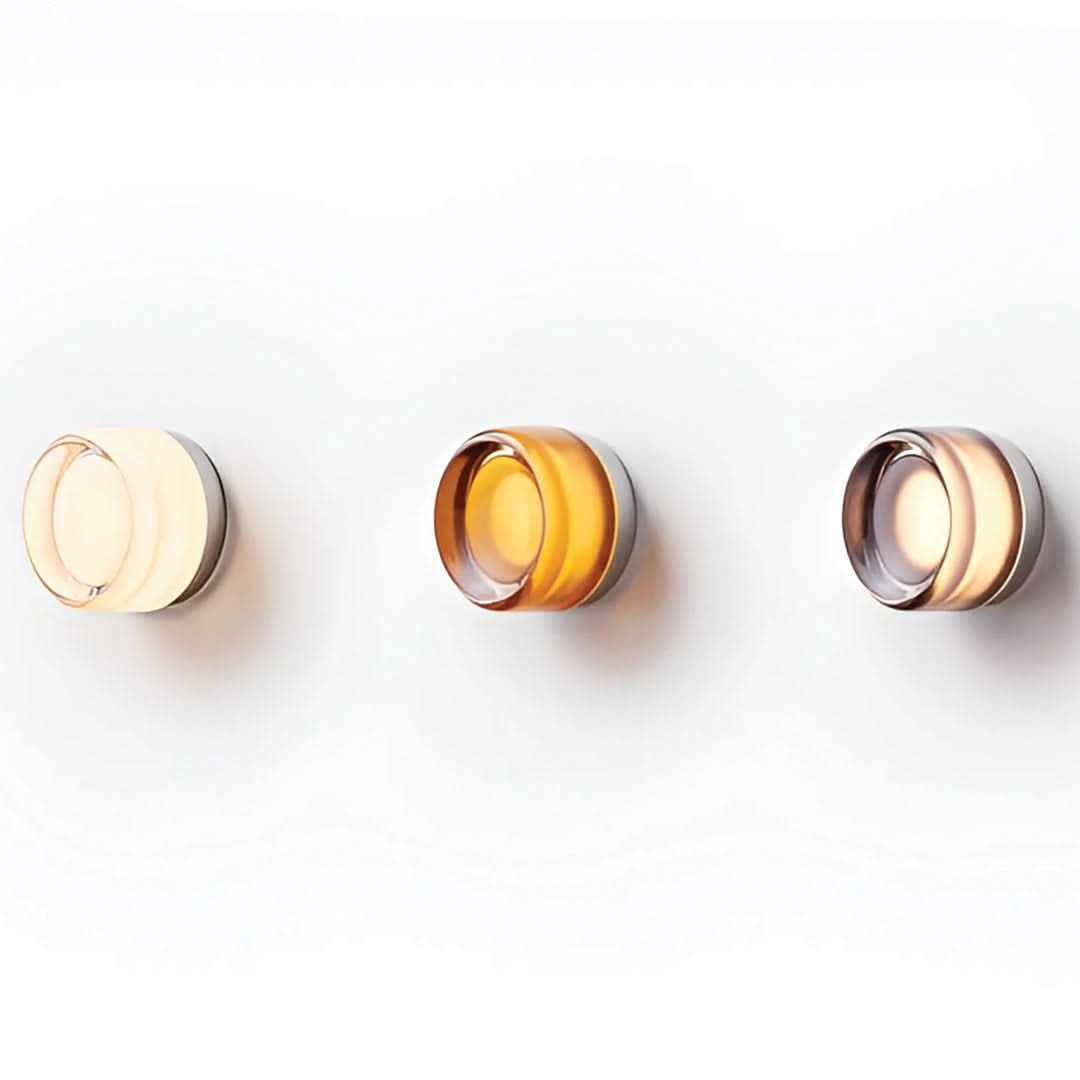Three wall-mounted lights with different color temperatures on a white background