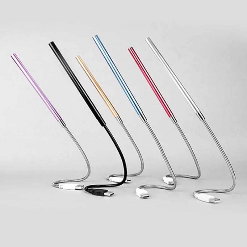 Set of colorful metal straws on a light gray background