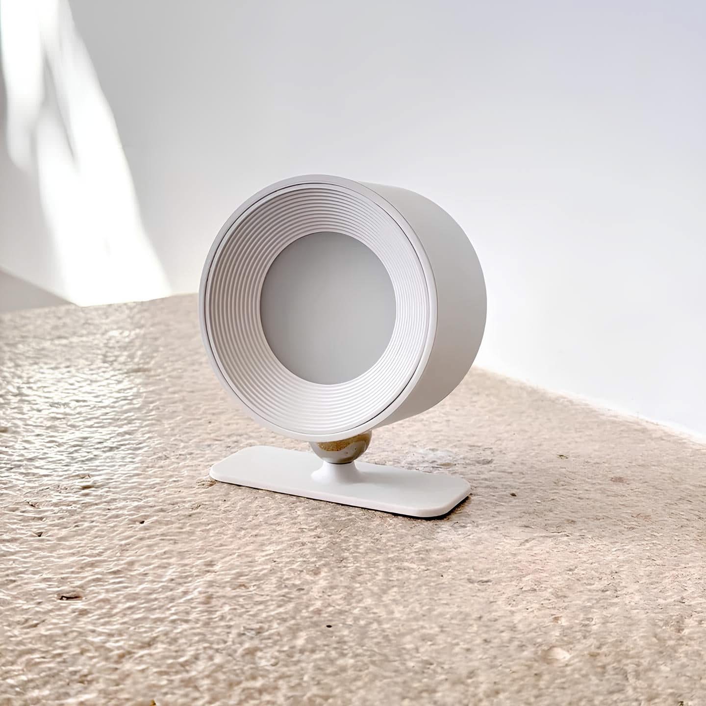 White cylindrical object on a textured surface with a light gray background