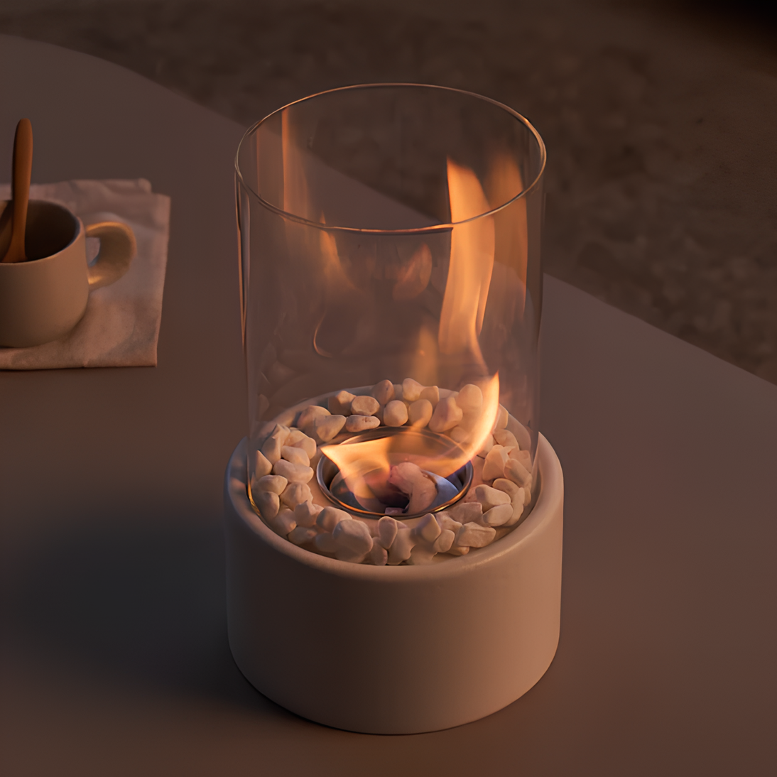 Small portable fireplace with flames inside a glass container on a dark surface.