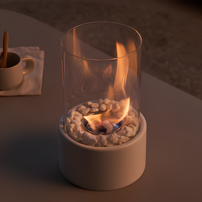 Small portable fireplace with flames inside a glass container on a dark surface.