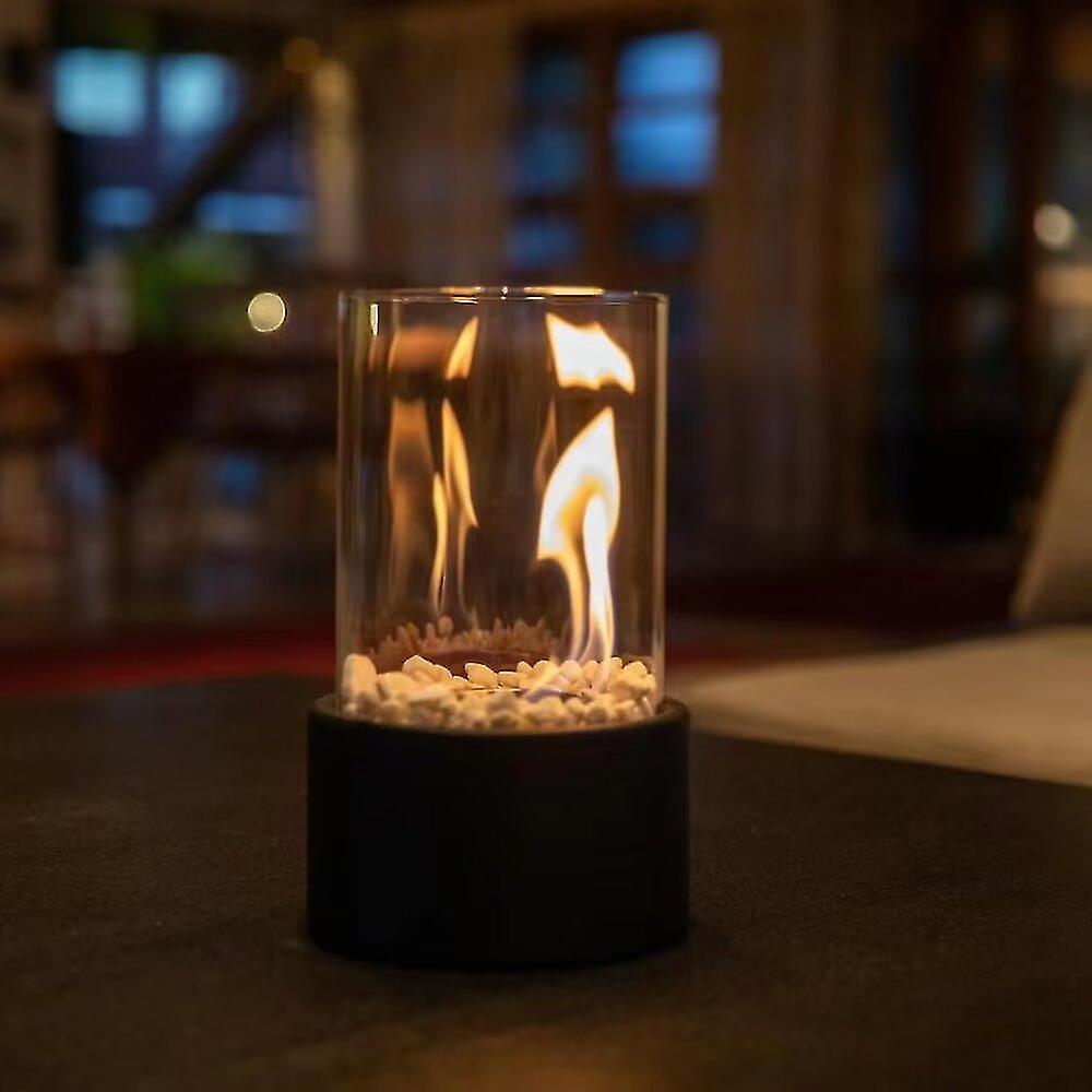 Small glass container with flames on a blurred background