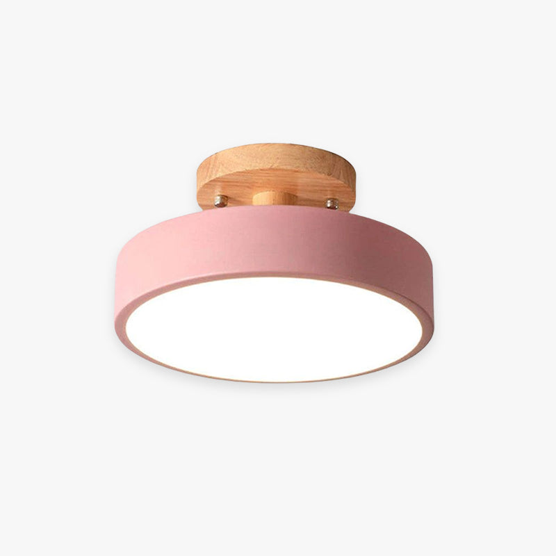 Ceiling light fixture with pink shade and wooden finish on a white background