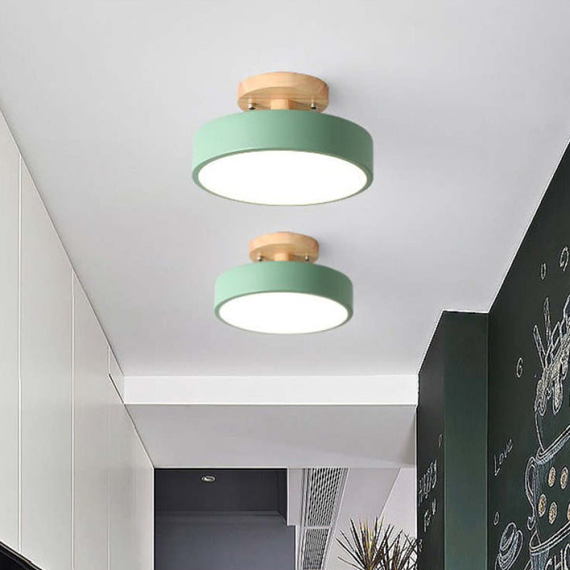 Two green ceiling lights with gold accents on a white ceiling.