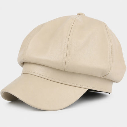Josh & Tate - LuxeDome™ Faux Leather Beret - A structured beige cap made of smooth faux leather, featuring a curved brim and a buttoned top crown, photographed on a light gray background.