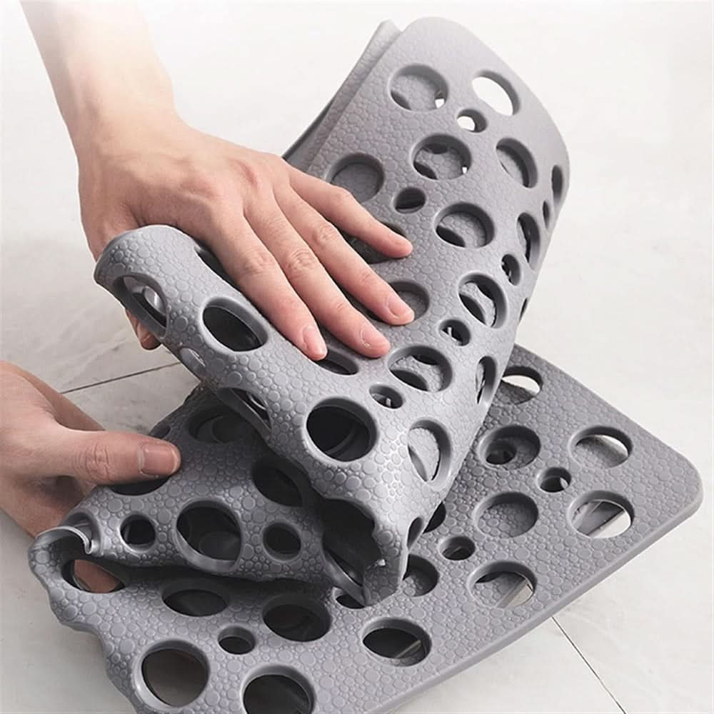Gray textured mat with hand demonstrating its size on a light background