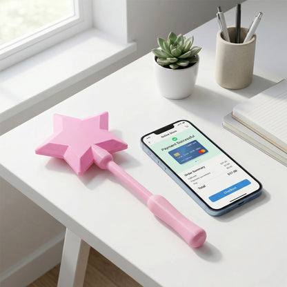 Josh & Tate - Magic Wand Cardholder - Pink star-shaped object on a desk with a smartphone displaying a payment success screen.