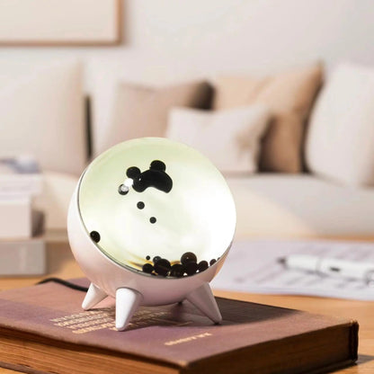 Decorative night light with cartoon character on a book in a living room setting