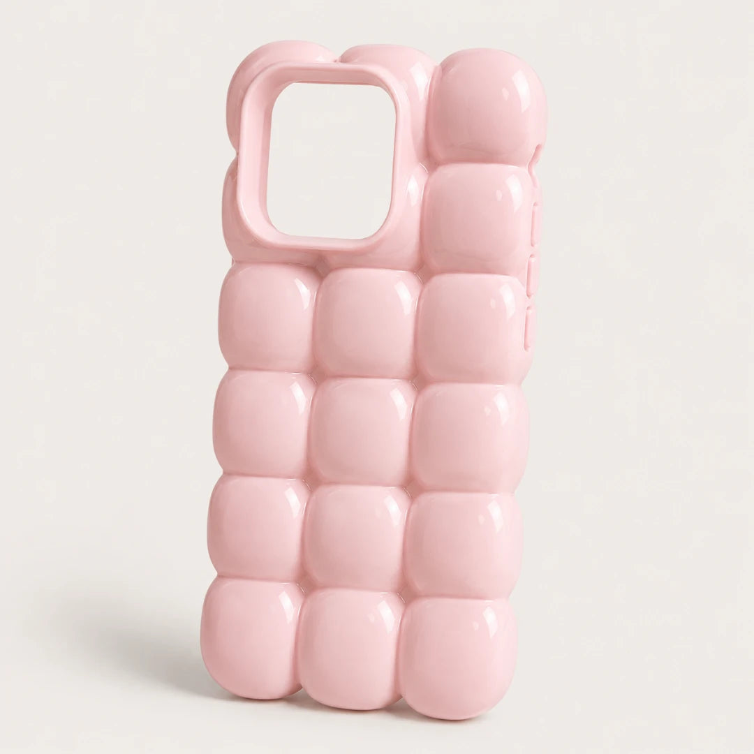 Josh & Tate - MarshBubble™ Puffy iPhone Case - A light pink phone case with a 3D bubbled, quilted texture and a camera cutout, shown on a light gray background.