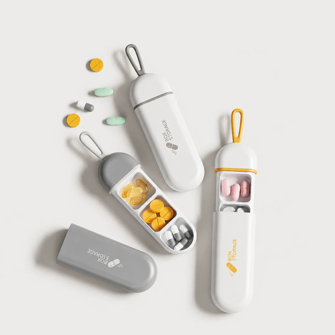 Josh & Tate - MedicineStorage™ Portable Pill Organizer - Three pill organizer cases with compartments and carry loops, shown open and closed on a light gray background with assorted pills scattered nearby. The cases are white and gray with yellow accents, and the brand name 'The Pill Storage' is visible on the front.