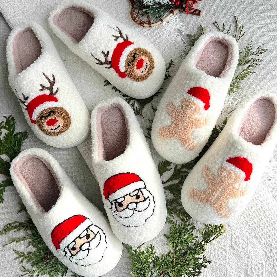 Set of white slippers with Christmas-themed designs on a decorative background