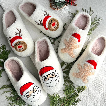 Set of white slippers with Christmas-themed designs on a decorative background