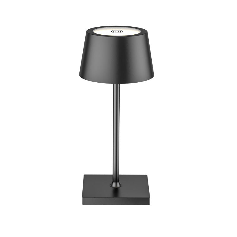 Black table lamp with a square base on a white background