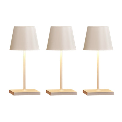 Three table lamps with beige lampshades and wooden bases on a white background