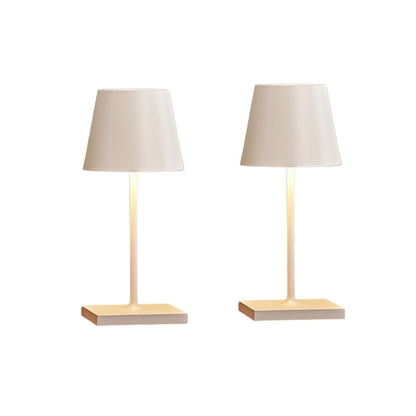 Two table lamps with beige lampshades and square wooden bases on a white background