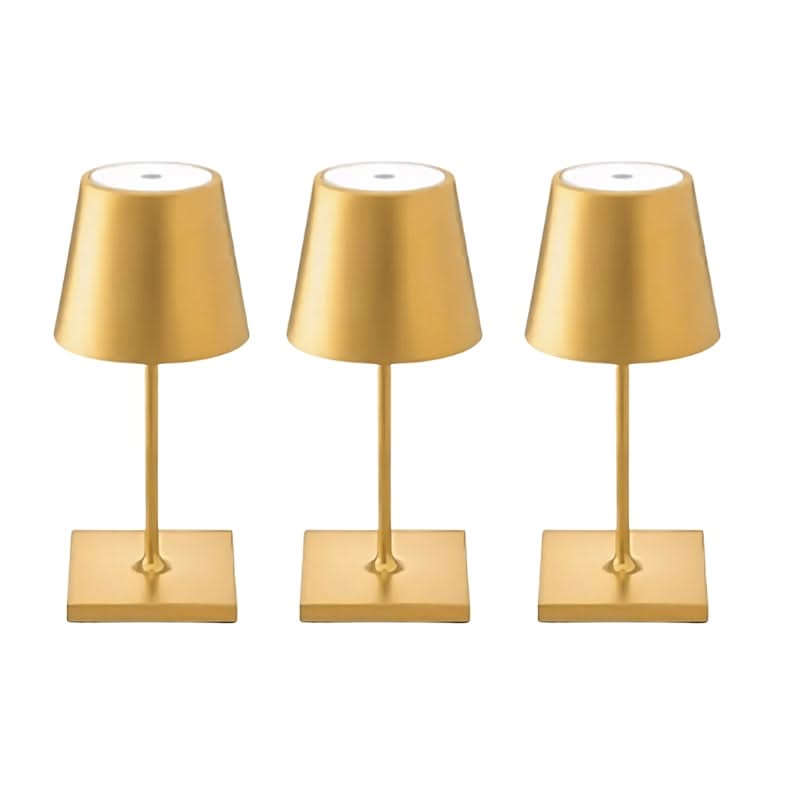 Three gold table lamps on a white background