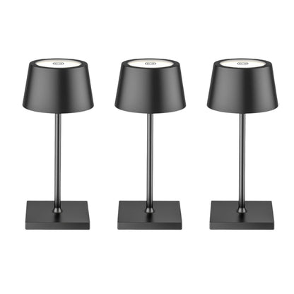 Three black table lamps with gray shades on a white background