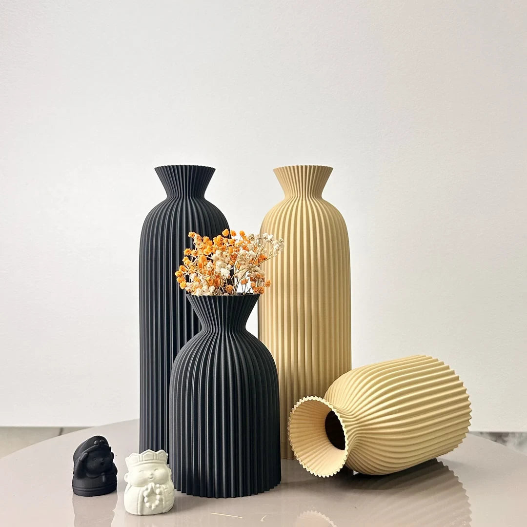 Josh & Tate - Minimalist Fluted Ceramic Vase Set - Set of black and beige vases on a light surface with a white background