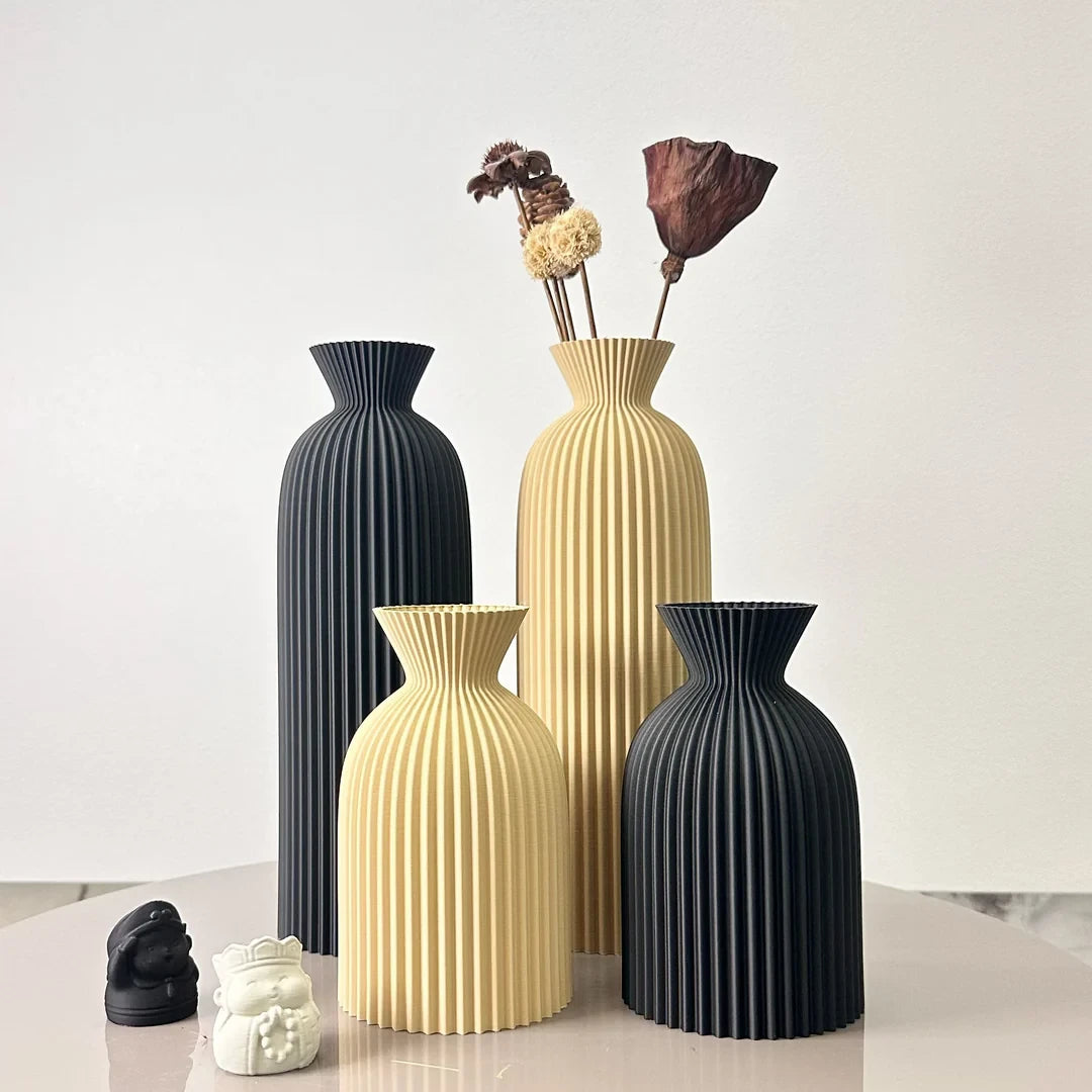 Josh & Tate - Minimalist Fluted Ceramic Vase Set - Set of four decorative vases in black and beige on a light surface with a white background