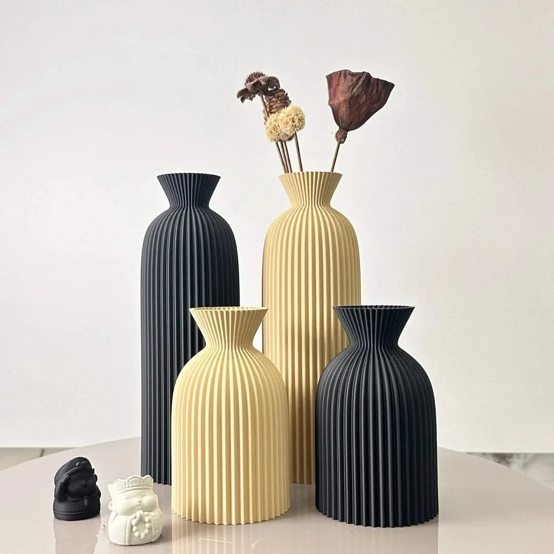 Josh & Tate - Minimalist Fluted Ceramic Vase Set - Set of four decorative vases in black and beige on a light surface with a white background
