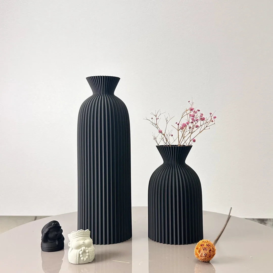 Josh & Tate - Minimalist Fluted Ceramic Vase Set - Two black vases on a reflective surface with a white background