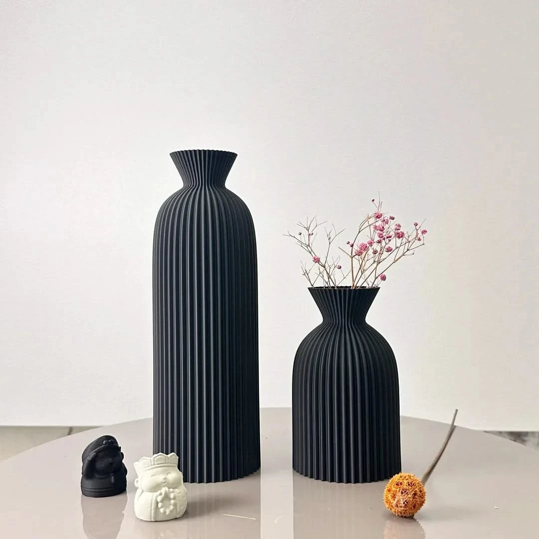 Josh & Tate - Minimalist Fluted Ceramic Vase Set - Two black vases on a reflective surface with a white background