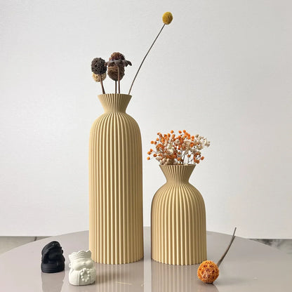 Josh & Tate - Minimalist Fluted Ceramic Vase Set - Two beige textured vases with dried flowers on a light surface and white background
