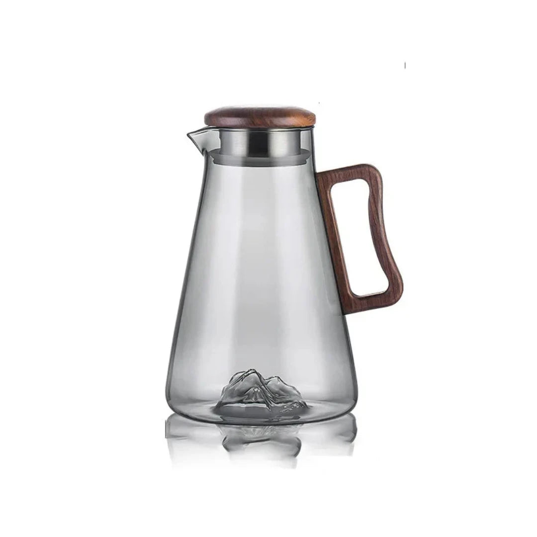 Josh & Tate - Montara Elegant Glass Pitcher - Clear glass pitcher with wooden lid and handle on a white background
