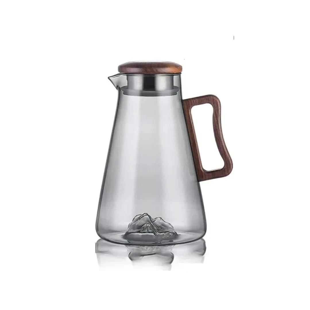 Josh & Tate - Montara Elegant Glass Pitcher - Clear glass pitcher with wooden lid and handle on a white background