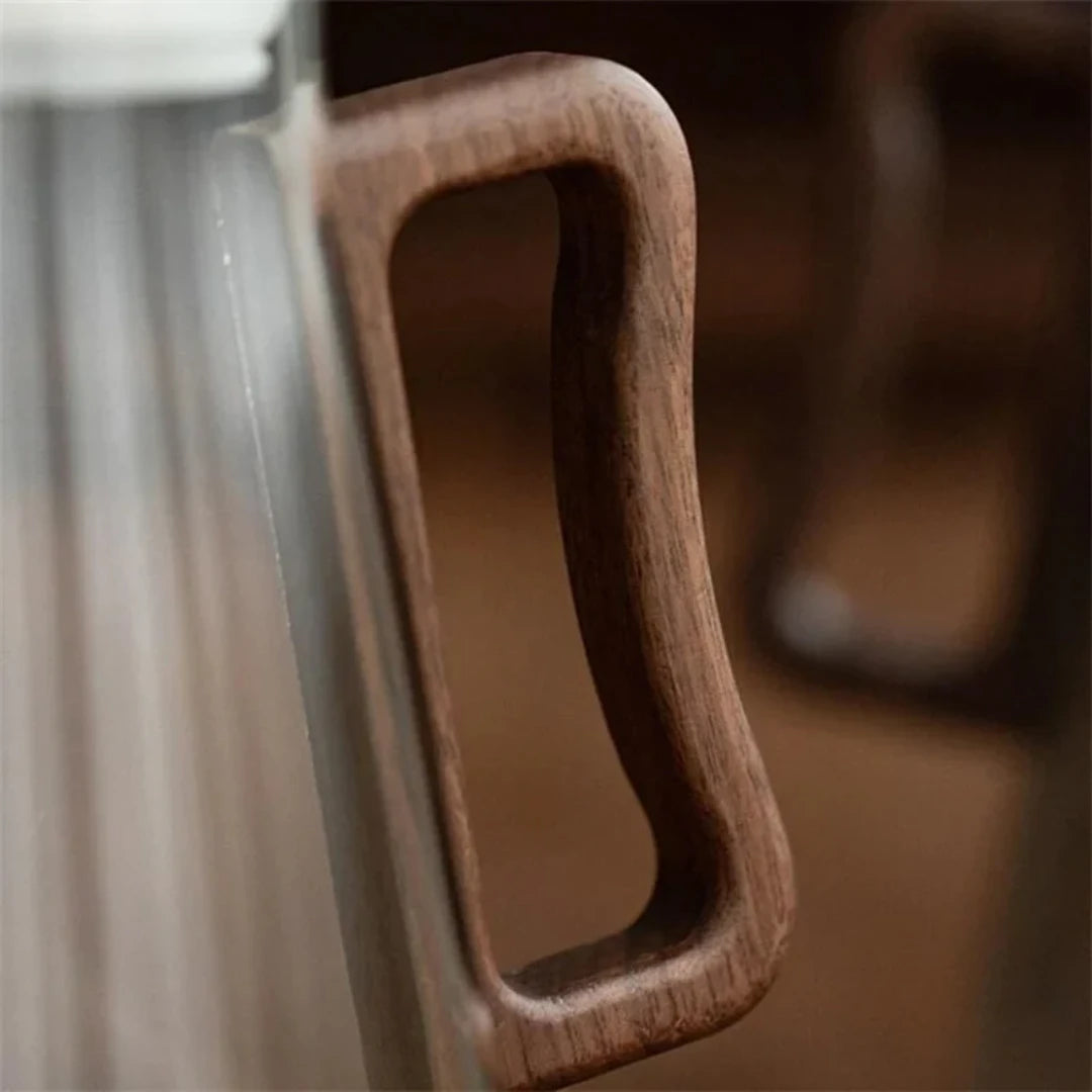 Josh & Tate - Montara Elegant Glass Pitcher - Close-up of a wooden handle on a glass door