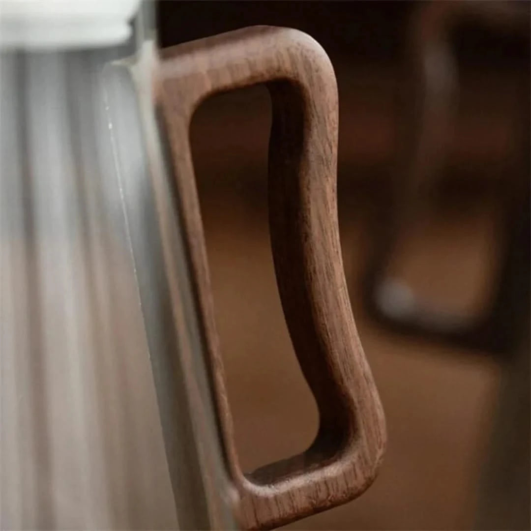 Josh & Tate - Montara Elegant Glass Pitcher - Close-up of a wooden handle on a glass door
