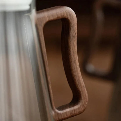 Josh & Tate - Montara Elegant Glass Pitcher - Close-up of a wooden handle on a glass door