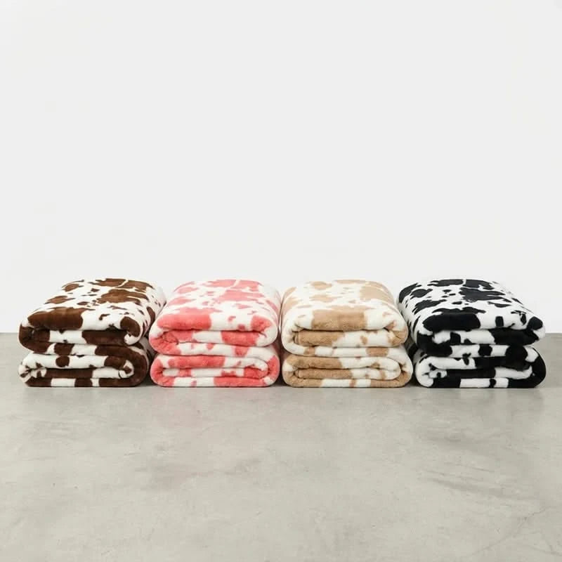 Josh & Tate MooWrap Cow Print Plush Blanket - all four color options side by side