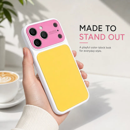 Josh & Tate - MoodBlock™ iPhone Case - A hand holds a white phone case with a bright yellow back panel and a pink camera cutout area. The case has a small visible logo near the top left and is shown against a bright indoor background with text reading 'MADE TO STAND OUT' and a coffee cup in the distance.