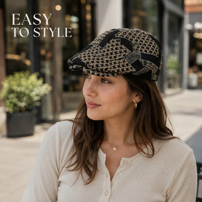 Josh & Tate - MosaicBrim™ Patchwork Flat Cap - A woman wearing a black and beige houndstooth flat cap with a black bow detail, posing outdoors on a city street. The text 'EASY TO STYLE' is displayed in the top left corner.