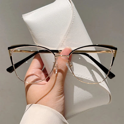 Josh & Tate - MuseCat™ Minimalist Cat-Eye Glasses - Hand holding a pair of gold-framed eyeglasses with a white case in the background