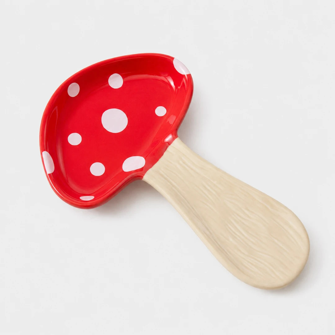 Josh & Tate - MushPerch™ Kitchen Spoon Holder - A mushroom-shaped spoon or scoop with a glossy red cap decorated with white polka dots and a light beige wood-grain handle, shown on a clean white background.