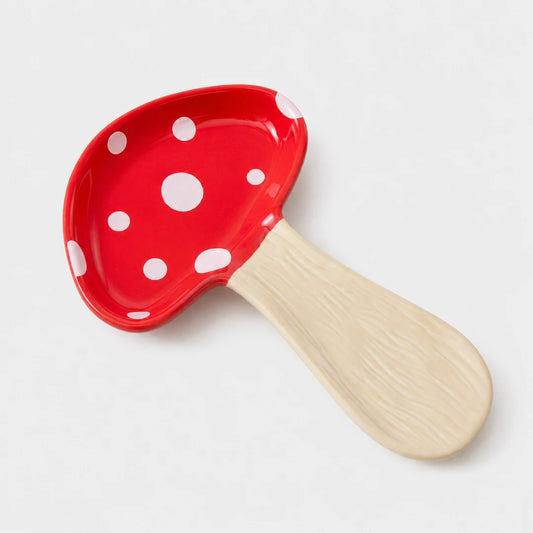 Josh & Tate - MushPerch™ Kitchen Spoon Holder - A mushroom-shaped spoon or scoop with a glossy red cap decorated with white polka dots and a light beige wood-grain handle, shown on a clean white background.