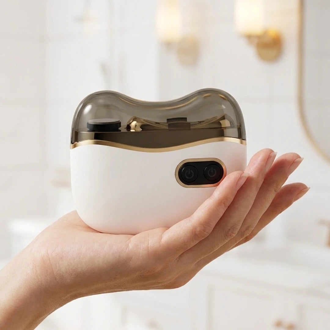 Josh & Tate - NailPod™ Automatic Nail Care System - Hand holding a white electronic device with a gold accent against a blurred background