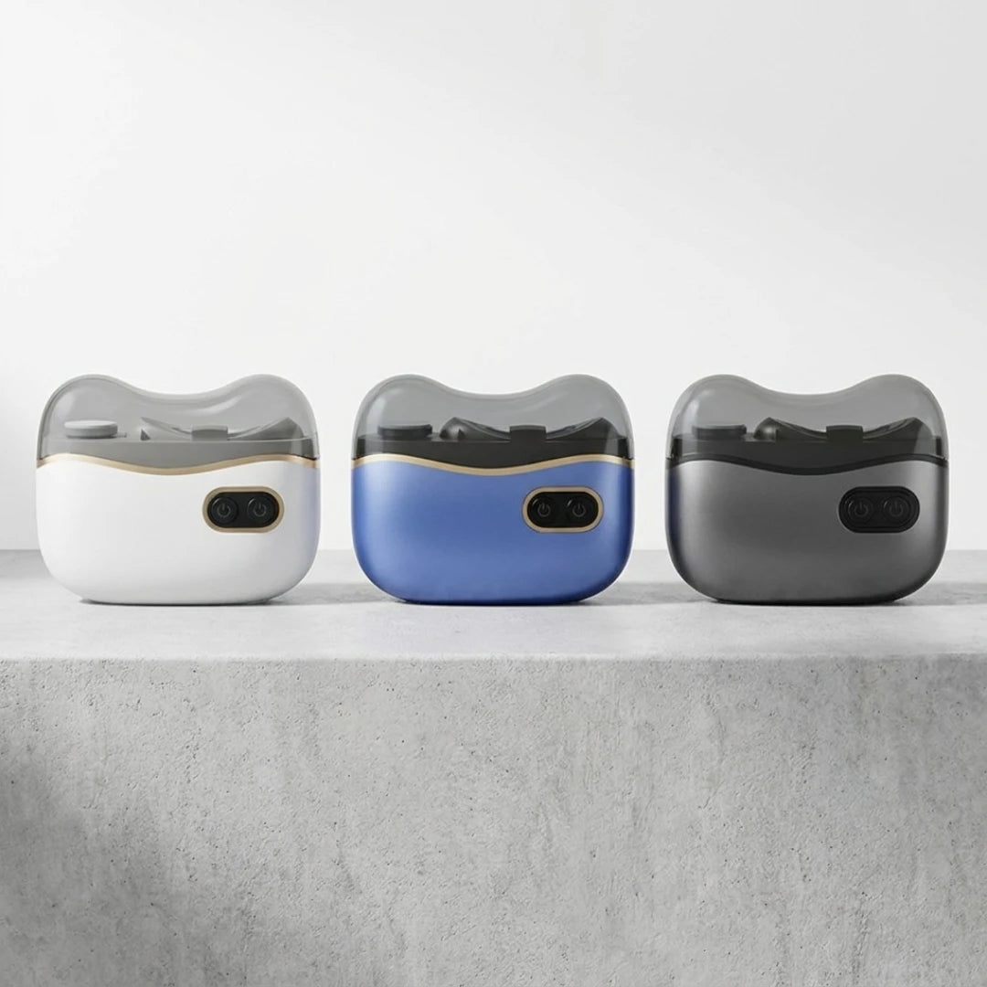 Josh & Tate - NailPod™ Automatic Nail Care System - Three electronic devices with different color options on a gray surface.